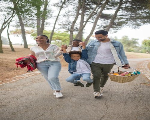 Happy family walking in park outdoors